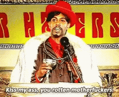 Man At Podium Holding Martini Saying Kiss My Ass You Rotten Motherfucker GIF