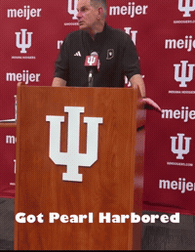 Man At Podium In Front Of Meijer Banner GIF