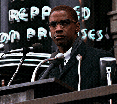 Man At Podium Speaking Into Microphones With Repealed On Process Sign GIF