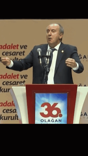 Man At Podium With 36 Sign GIF