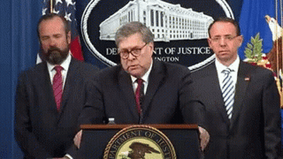 Man At Podium With Department Of Justice Logo GIF