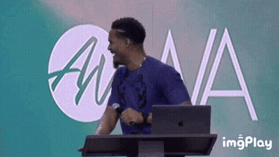 Man At Podium With Microphone And Laptop GIF