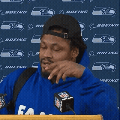 Man At Podium With Microphone In Front Of Boeing Logo GIF