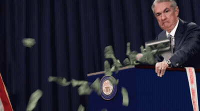 Man At Podium With Money Flying Out GIF