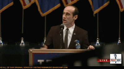Man At Podium With Right Side Sign GIF