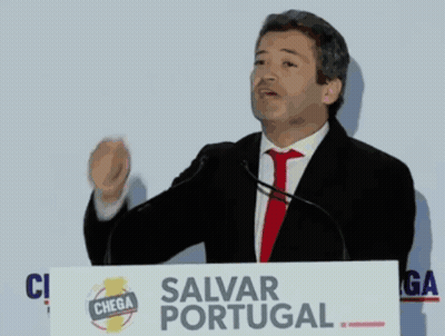 Man At Podium With Salvar Portugal Sign GIF