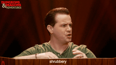 Man At Podium With Shrubbery Sign GIF