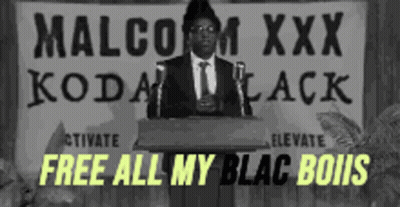 Man At Podium With Sign Saying Malcolm XXX Kodak Black GIF