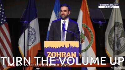 Man At Podium With Turn The Volume Up Behind Him GIF
