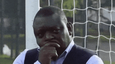 Man At Soccer Net Hand On Chin Looking At Camera GIF