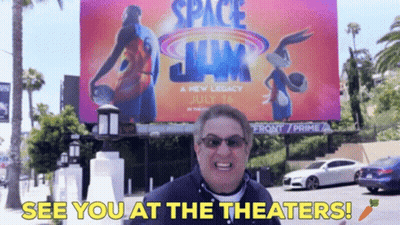 Man At Space Jam Billboard Says See You At Theaters GIF