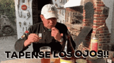 Man At Table With Beer And Tapense Los Ojos GIF