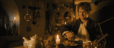 Man At Table With Candle Doorbell Rings GIF
