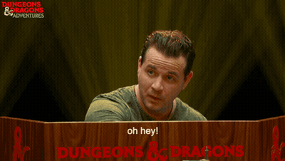 Man At Table With Dungeons And Dragons Sign GIF