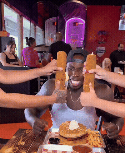 Man At Table With Food And Gatorade Sign GIF