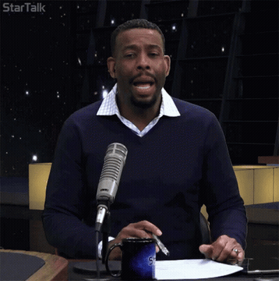 Man At Table With Microphone And Startalk Logo GIF