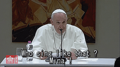 Man At Table With Microphone Saying Who Sing I Like That Mina GIF