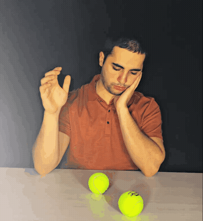 Man At Table With Slazenger Tennis Balls GIF