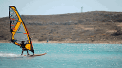 Man Balancing While Windsurfing