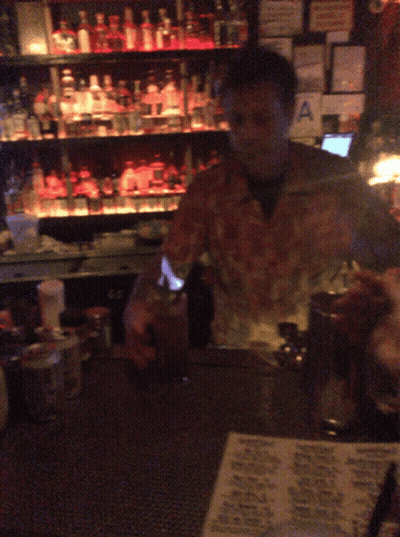 Man Behind Bar With Hawaiian Menu GIF