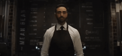 Man Behind Counter Arms Outstretched He's Baaack GIF