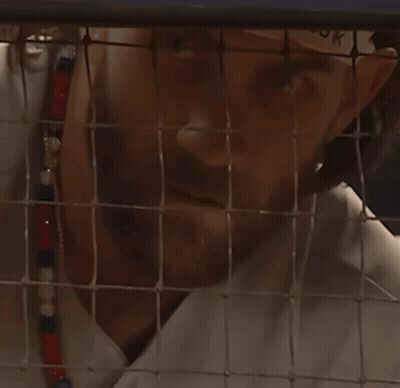 Man Behind Fence Looking At Camera GIF