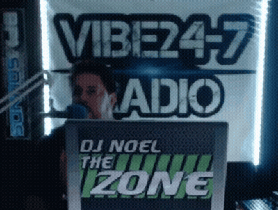 Man Behind Microphone In Front Of DJ Noel The Zone Sign GIF