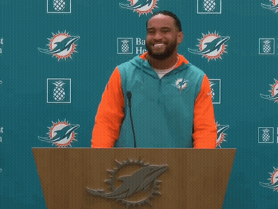Man Behind Podium With Dolphin Logo GIF