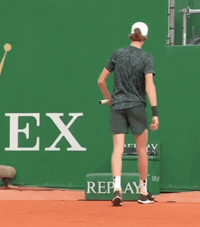 Man Bending Over To Pick Up Tennis Racket GIF