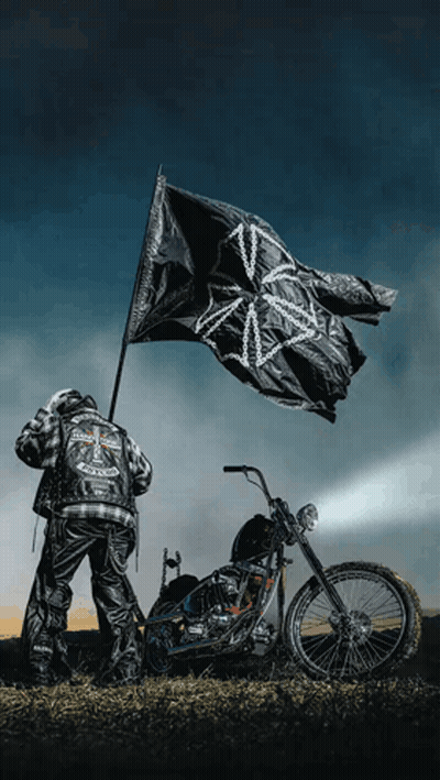 Man Beside Motorcycle Holding Black Flag GIF