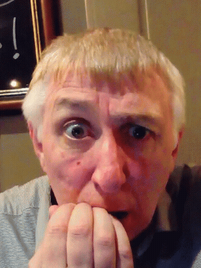 Man Biting Nails In Front Of Clock GIF