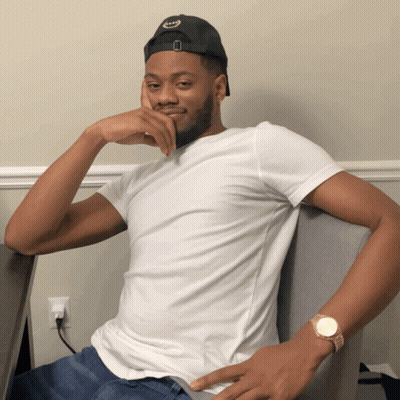 Man Black Hat White Shirt Sitting In Chair GIF