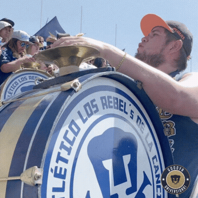 Man Blowing Into Drum Los Rebels