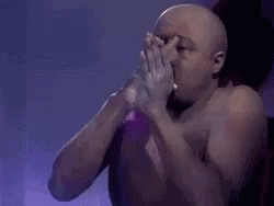 Man Blows Powder GIF