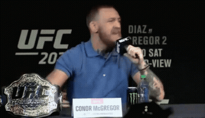 Man Blue Shirt Holding Microphone And UFC Belt GIF