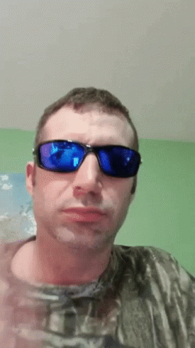 Man Blue Sunglasses Camo Shirt Looking At Camera GIF