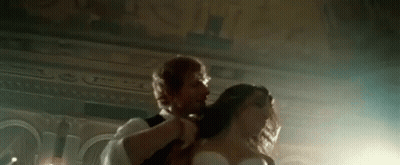 Man Brushing Woman's Hair While Dancing