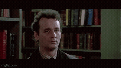 Man By Bookshelf So What Do We Do GIF