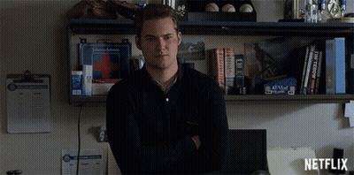 Man By Shelf With First Aid Kit And Netflix Logo GIF