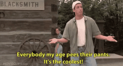 Man By Sign Everybody My Age Pees Their Pants GIF
