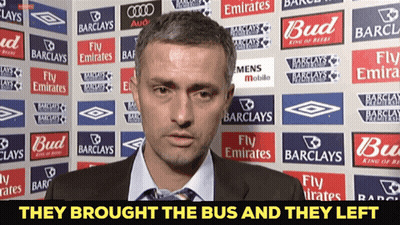 Man By Wall With Barclays And Emirates Ads GIF