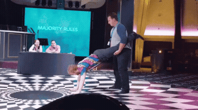 Man Carrying Another Man On Shoulders In Front Of Majority Rules Screen GIF