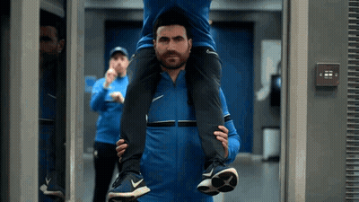 Man Carrying Another Man On Shoulders In Gym GIF