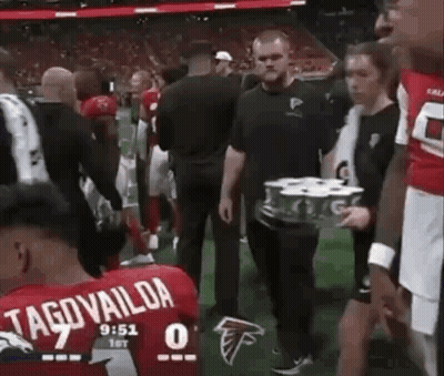 Man Carrying Beer Tray on Football Field