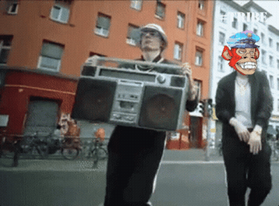 Man Carrying Boombox With Monkey Face on Head