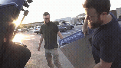 Man Carrying Box In Front Of Old Navy Store GIF