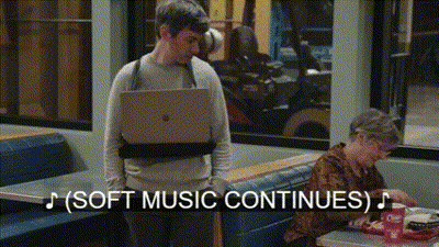 Man Carrying Laptop In Diner GIF