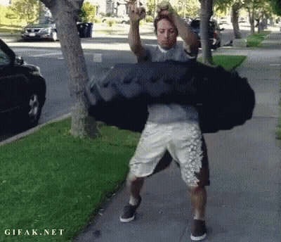Man Carrying Large Black Bag GIF