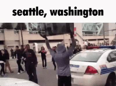 Man Carrying Large Object Over Head Seattle Washington GIF