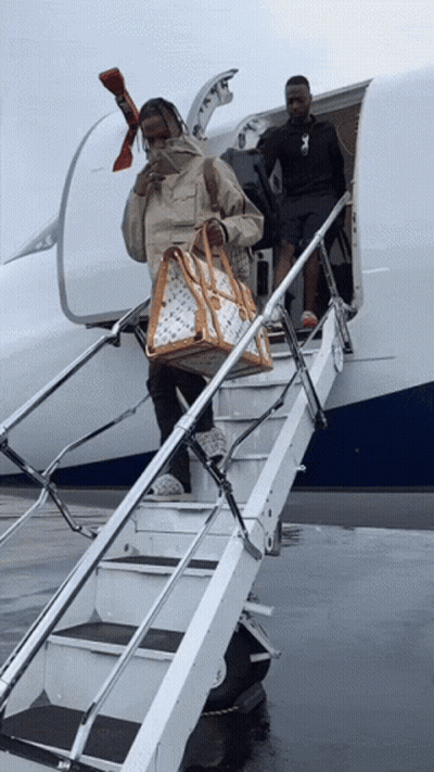Man Carrying Louis Vuitton Bag Walking Down Stairs GIF